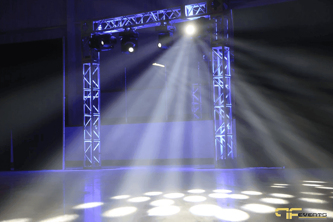 Truss arch on the ice with moving heads throwing white beams and gobo dots