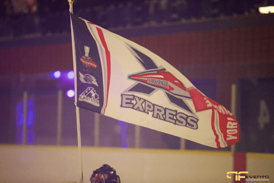 York Simcoe Express flag waved in the arena stands under purple light