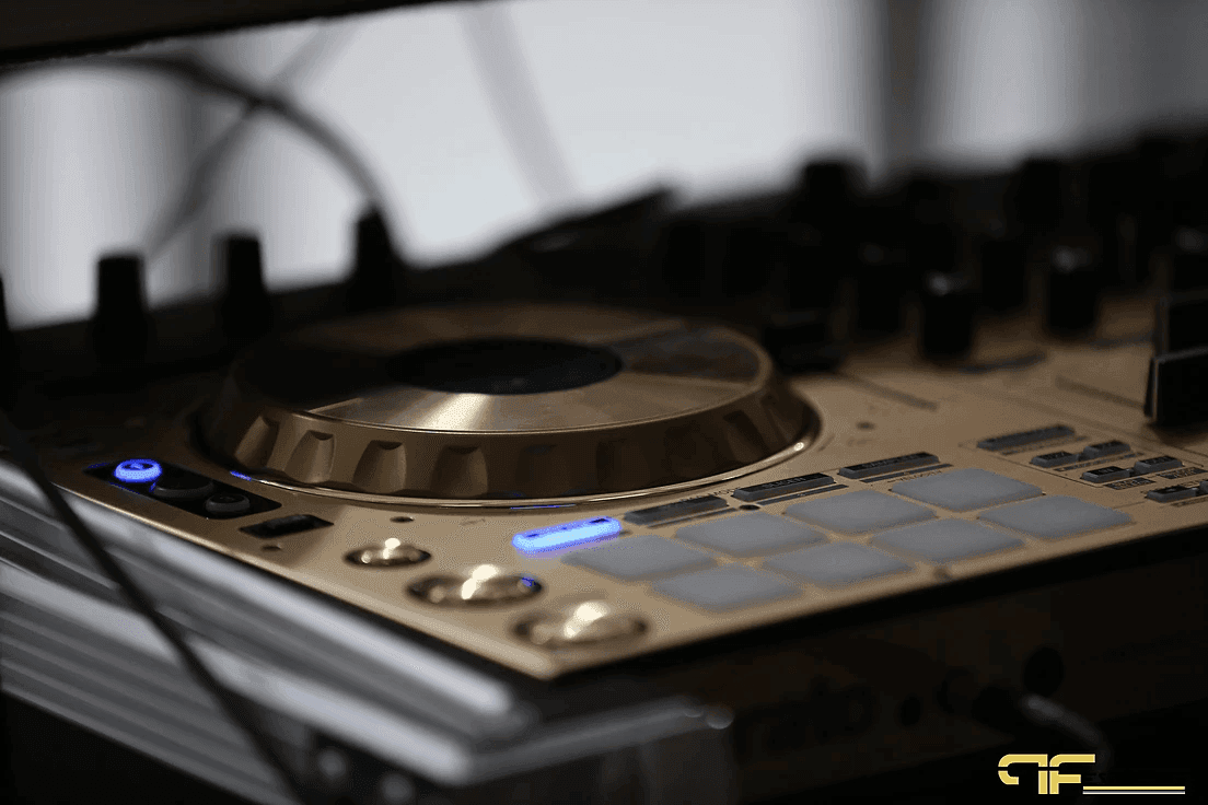 Close-up of a gold DJ controller jog wheel and pads