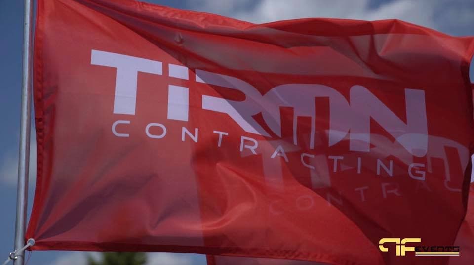 Red Tiron Contracting flag against a blue sky