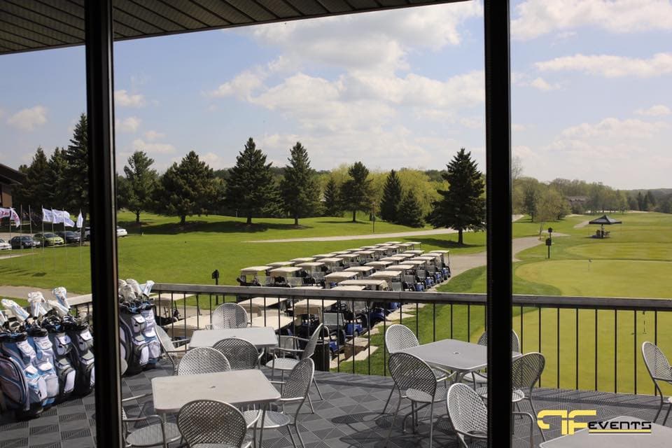 Clubhouse patio at Nobleton Lakes overlooking lined-up golf carts