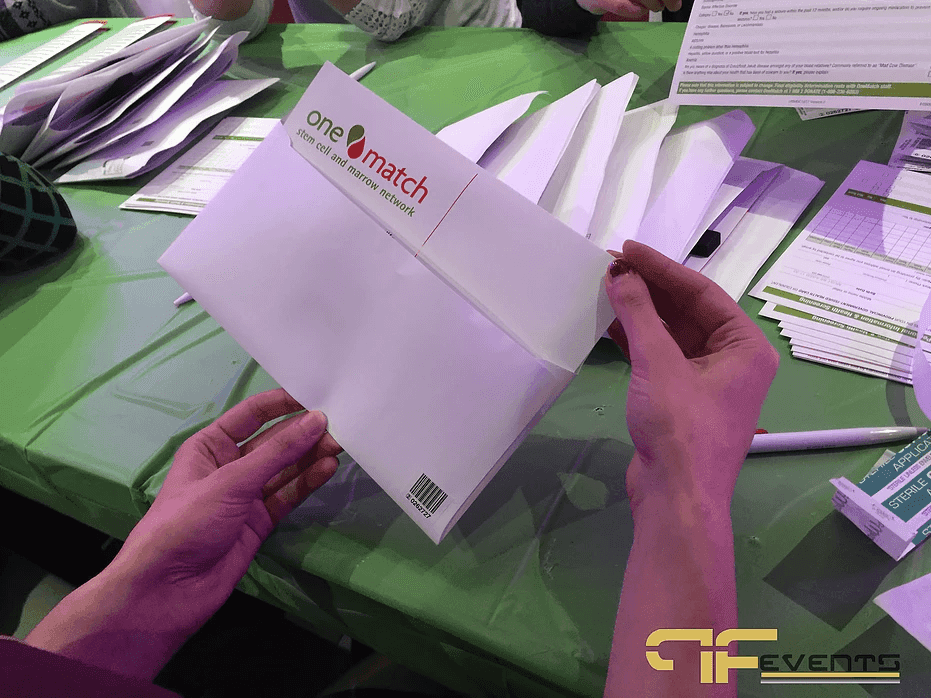 Volunteer holding a OneMatch stem cell and marrow network envelope