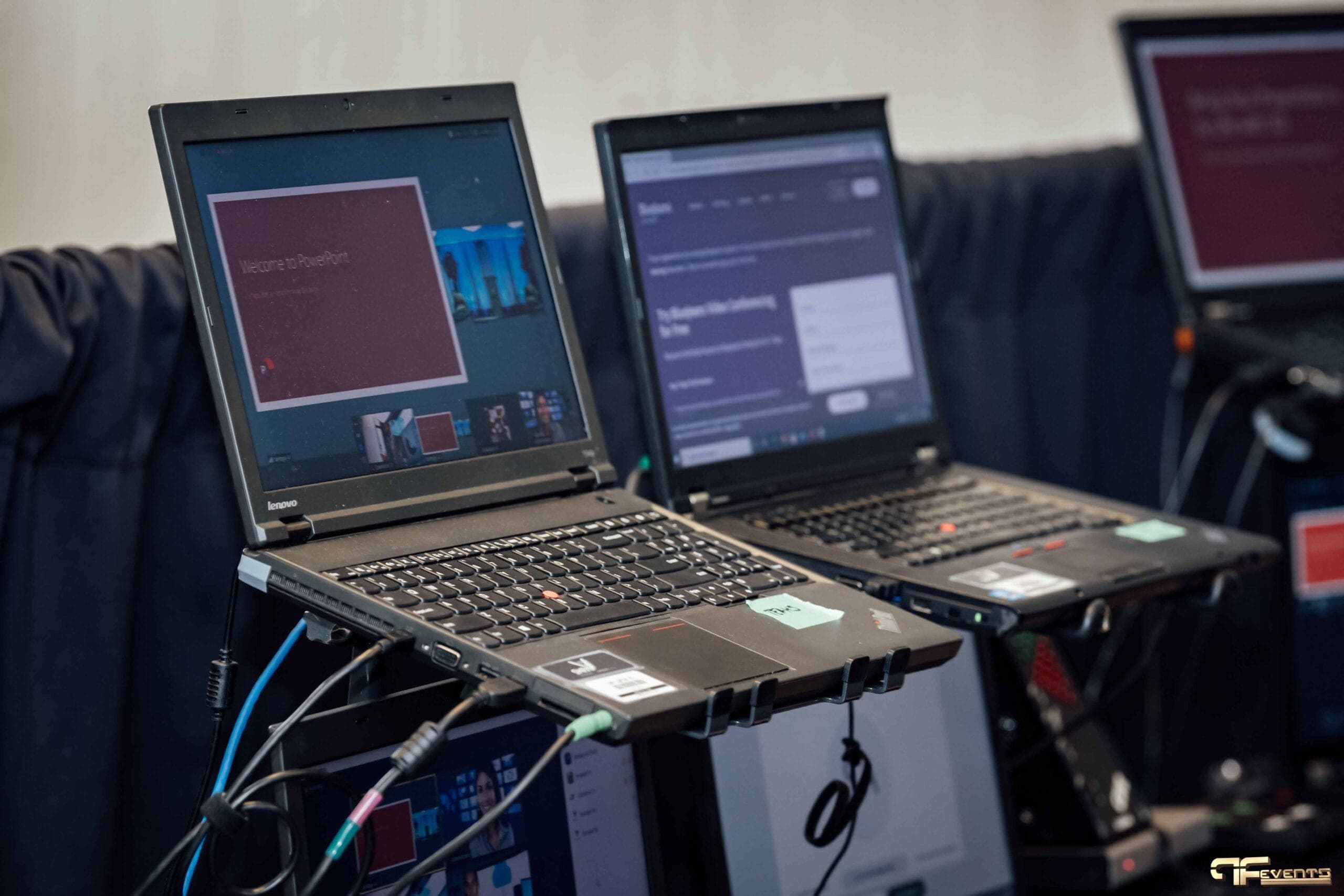 ThinkPad laptops on stands running presenter feeds for a virtual event